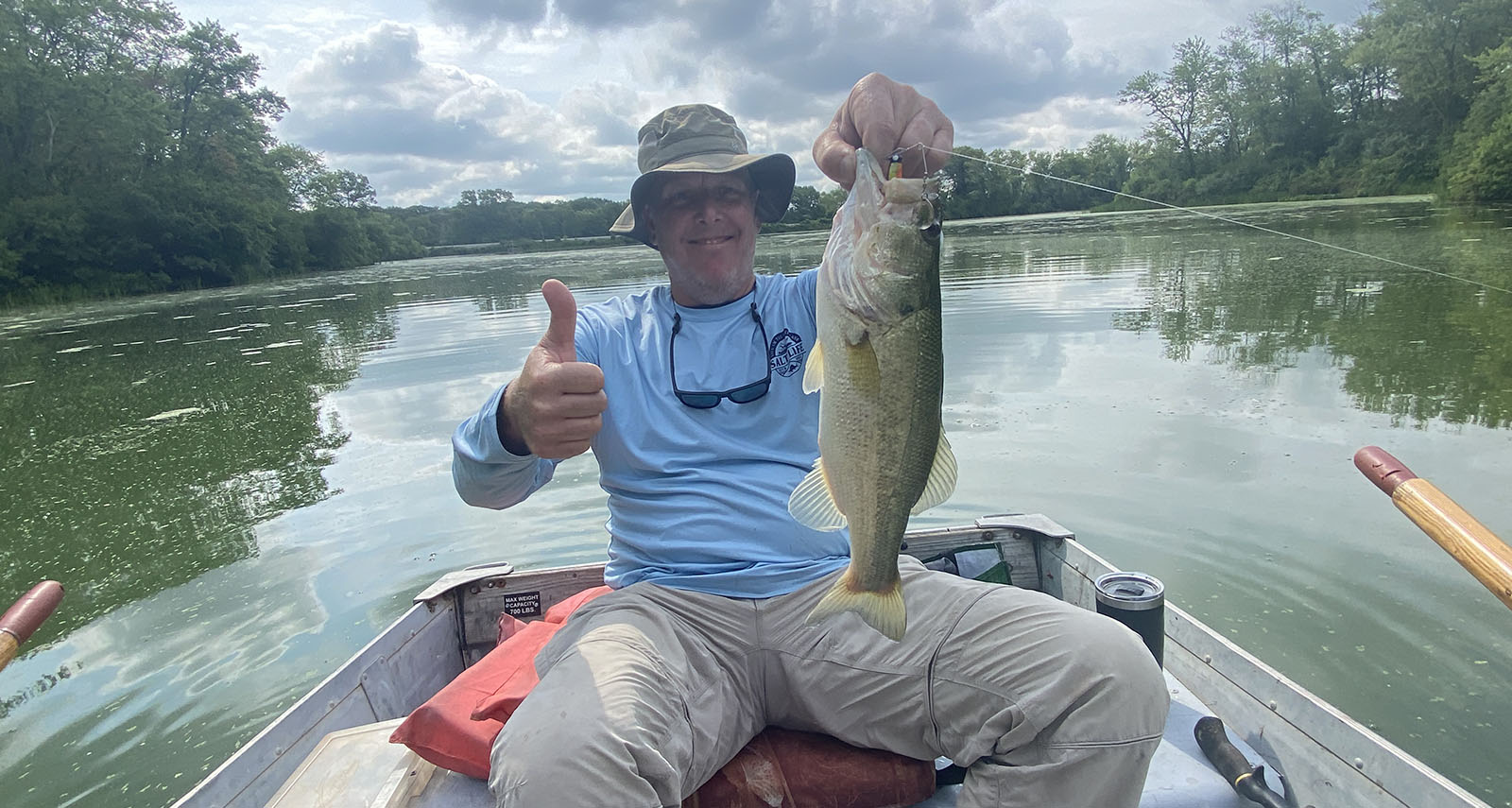 man in boat with fish